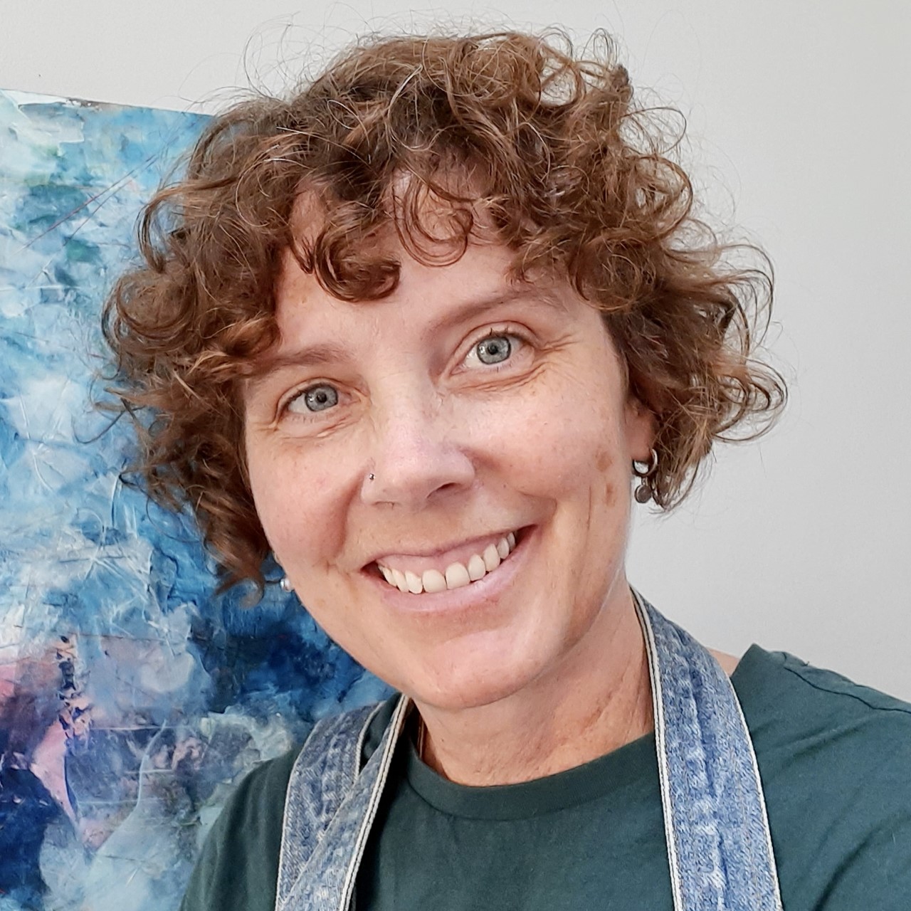 portrait photo of artist Hattie Lockhart-Smith in front of a painting